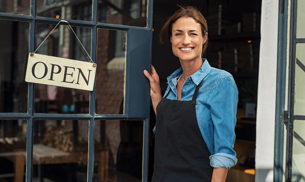 Woman at small business entrance