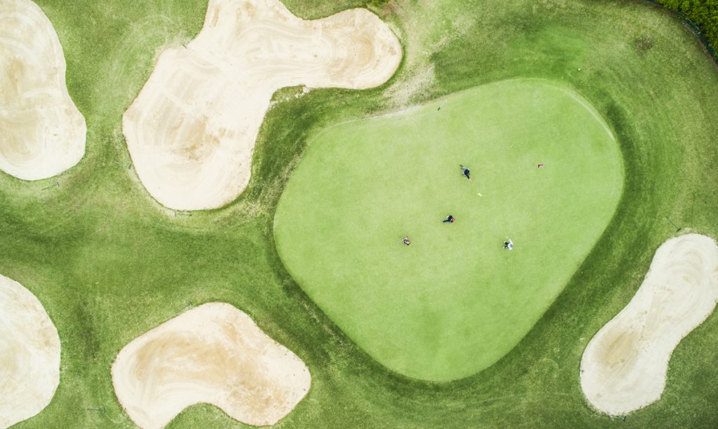 Aerial photograph of a golf course on a sunny day.